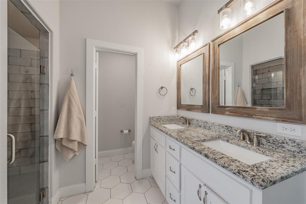 141 Maverick Lane Pilot Point, TX 76258 - Photo 37 of 40 a bathroom with a granite countertop sink and a mirror