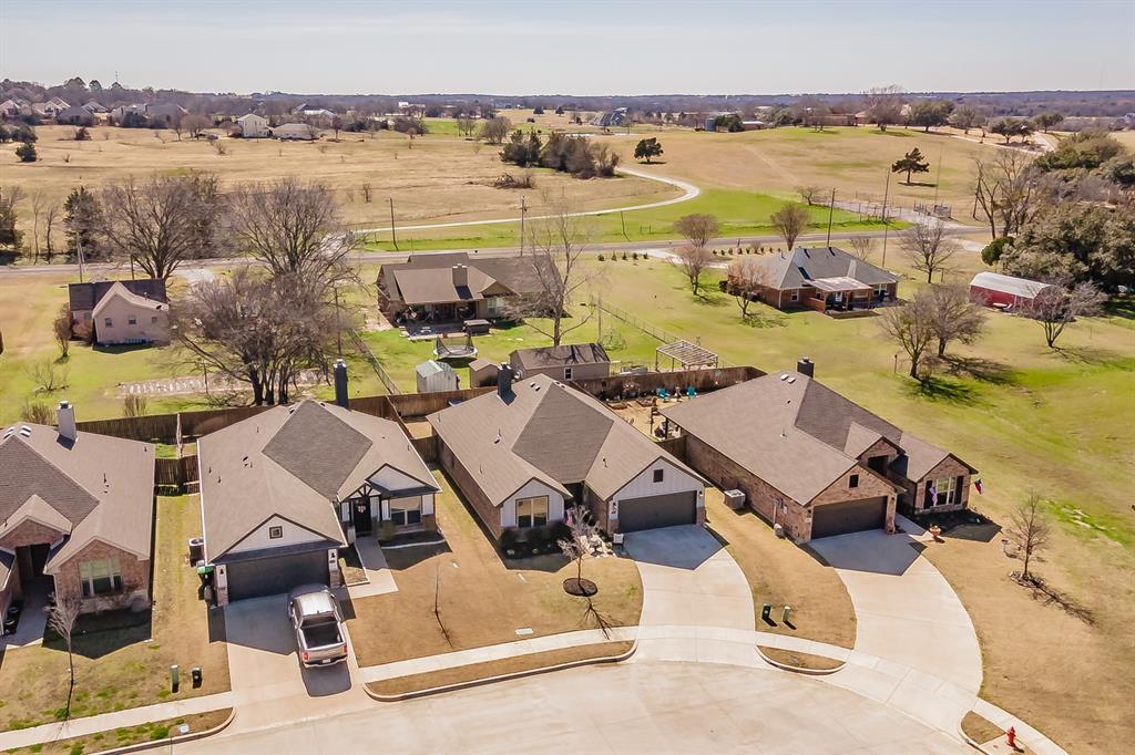 141 Maverick Lane Pilot Point, TX 76258 - Photo 5 of 40 an aerial view of a house with outdoor seating space and lake view