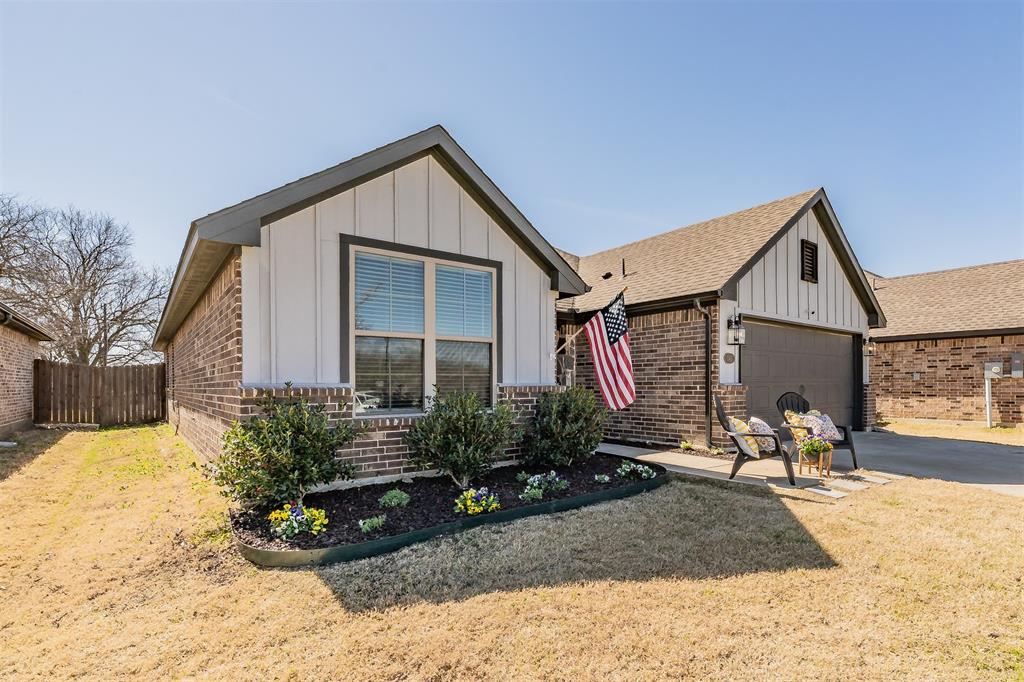 141 Maverick Lane Pilot Point, TX 76258 - Photo 8 of 40 a front view of a house with garden