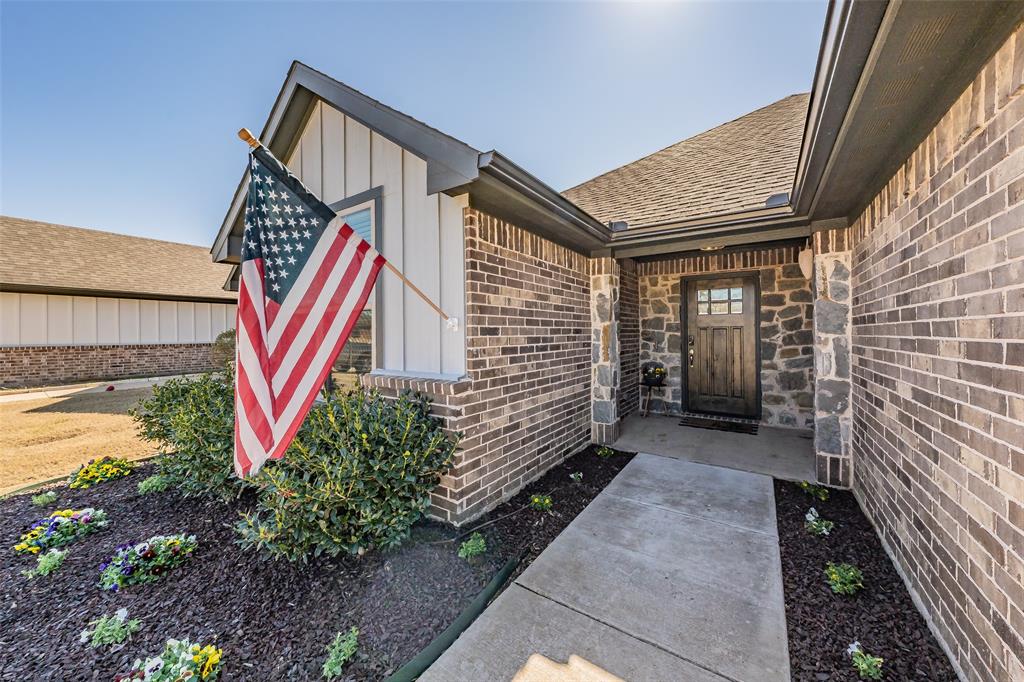 141 Maverick Lane Pilot Point, TX 76258 - Photo 10 of 40 a view of house with a yard and potted plants