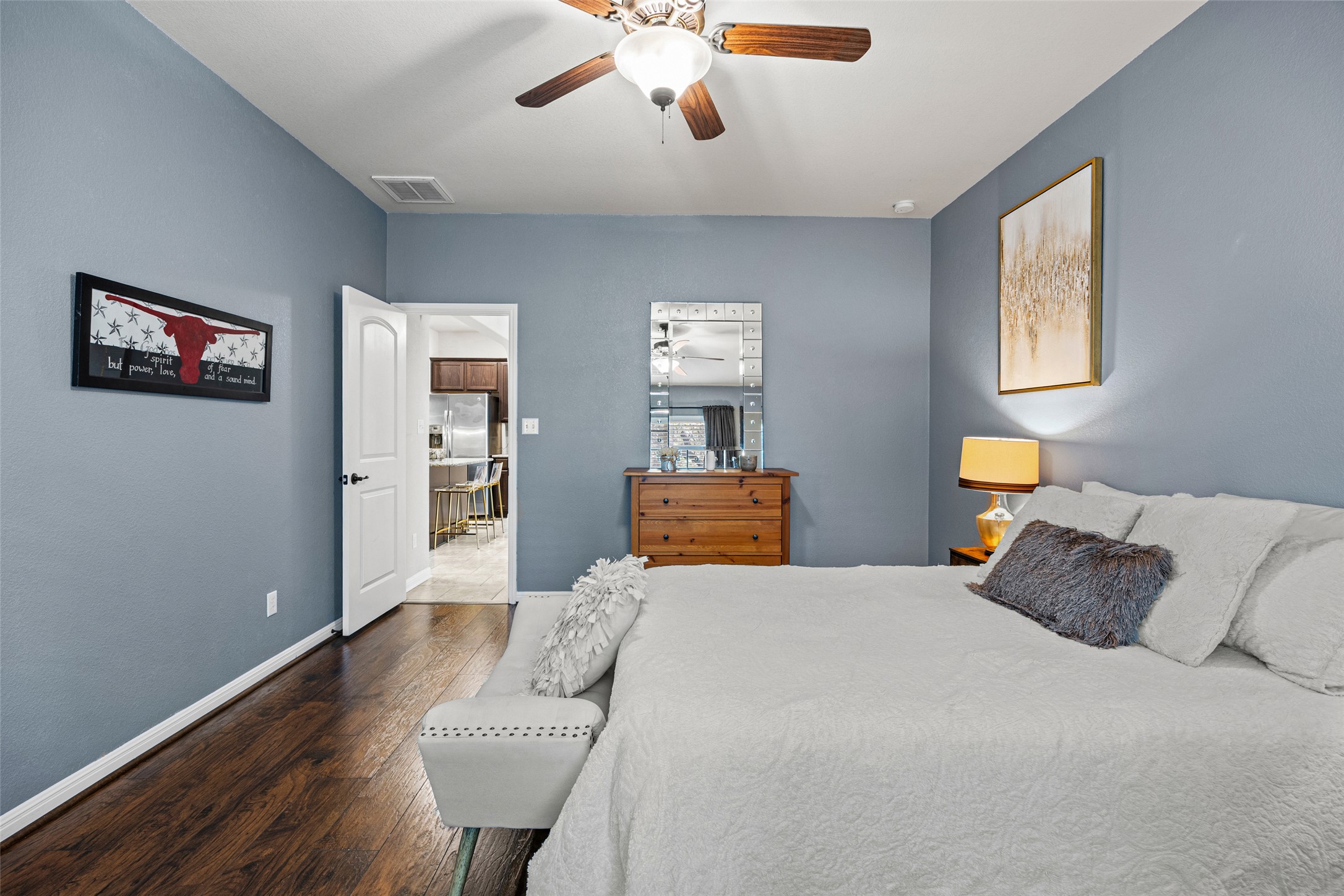 3451 Mayfield Ranch Boulevard, Unit 201 Round Rock, TX 78681 - Photo 15 of 29 a bedroom with a bed and wooden floor