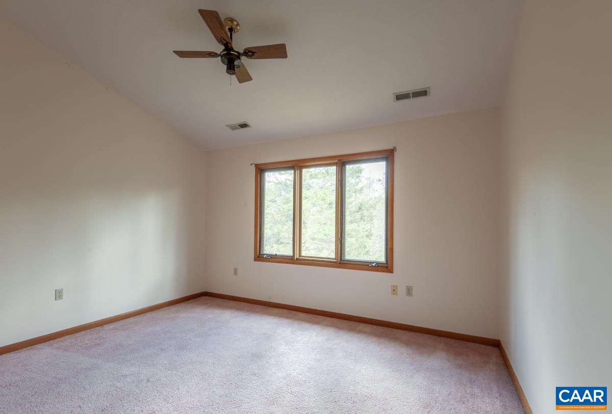 3849 Buck Island Road Charlottesville, VA 22902 - Photo 25 of 50 an empty room with a window and a fan