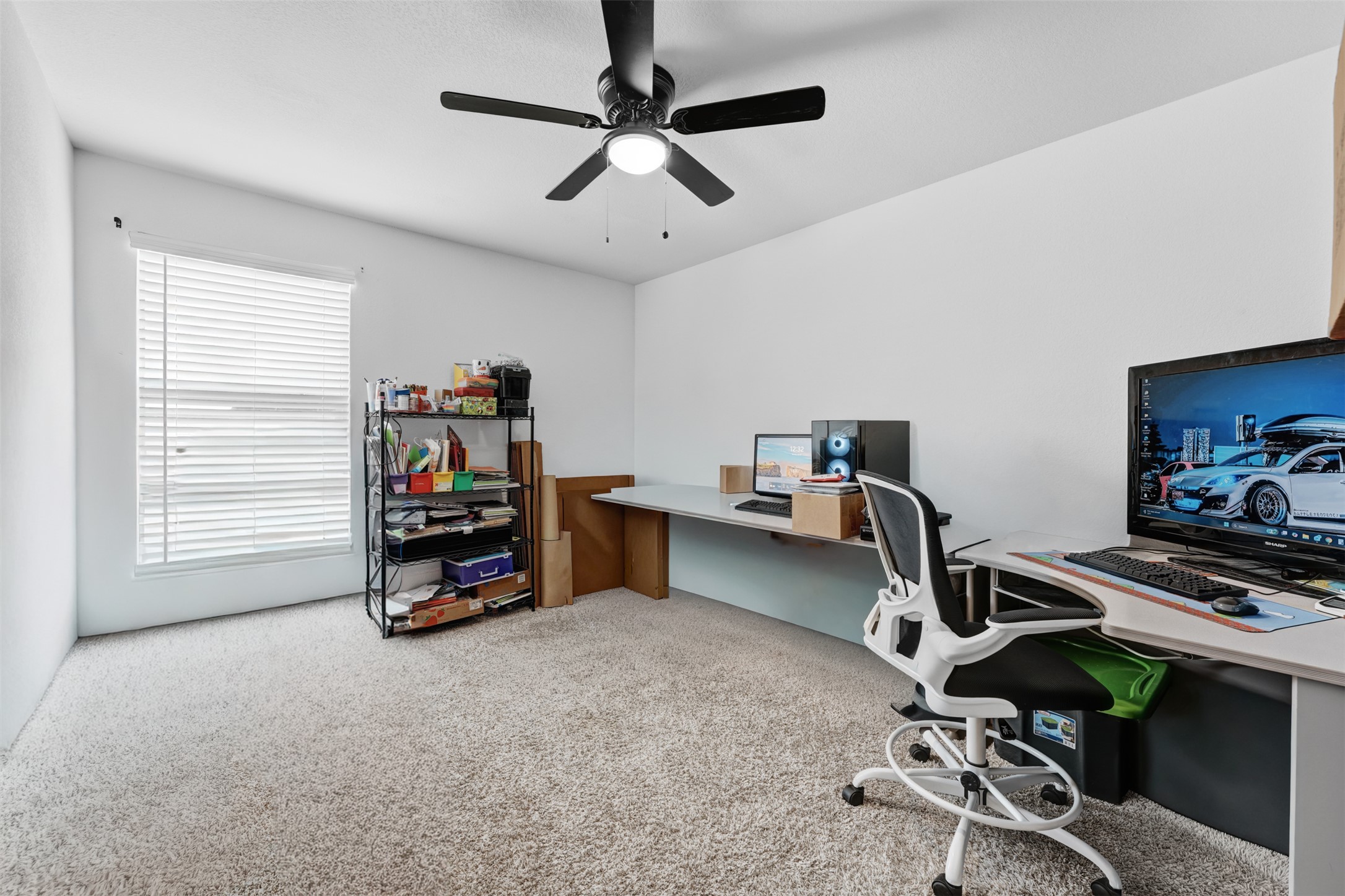 413 Perfect World Loop Jarrell, TX 76537 - Photo 30 of 39 Well-lit room provides a functional workspace, with carpeted flooring and an overhead ceiling fan.