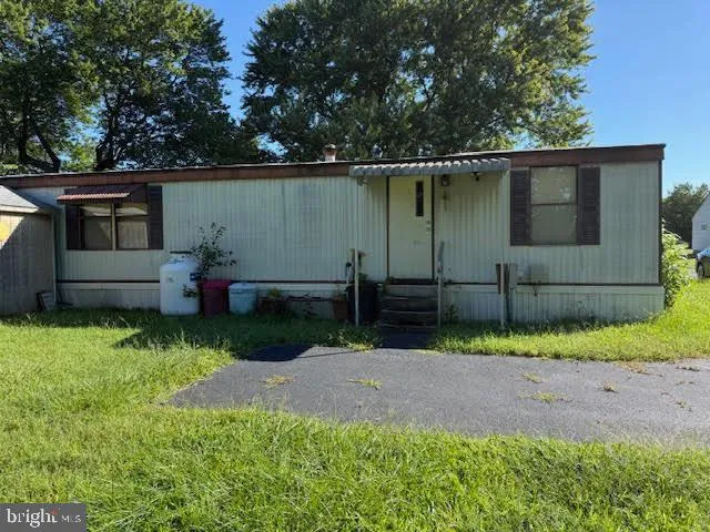 a view of backyard with wooden fence