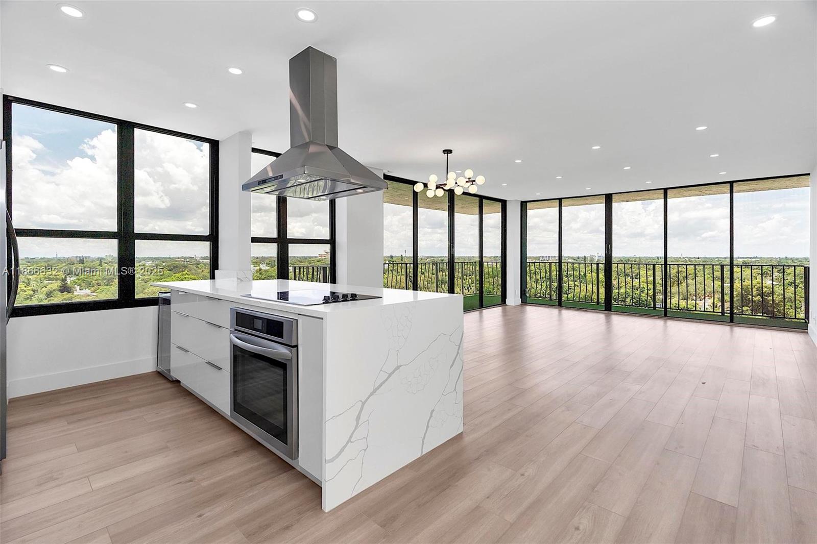 a open kitchen with stainless steel appliances granite countertop a stove and wooden floor