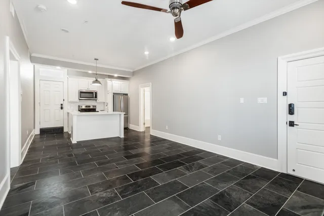 a kitchen with a refrigerator and white cabinets