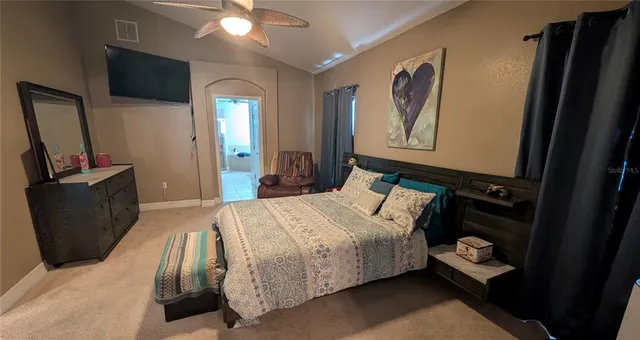 a bedroom with a bed and a flat screen tv