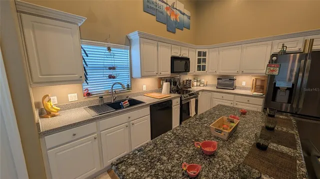 a kitchen with a sink stove and refrigerator