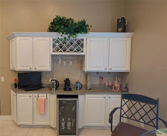 a kitchen with stainless steel appliances white cabinets and a stove top oven