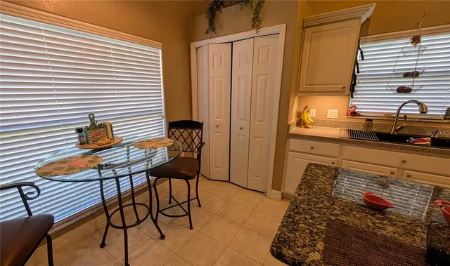 a view of a balcony with table and chairs