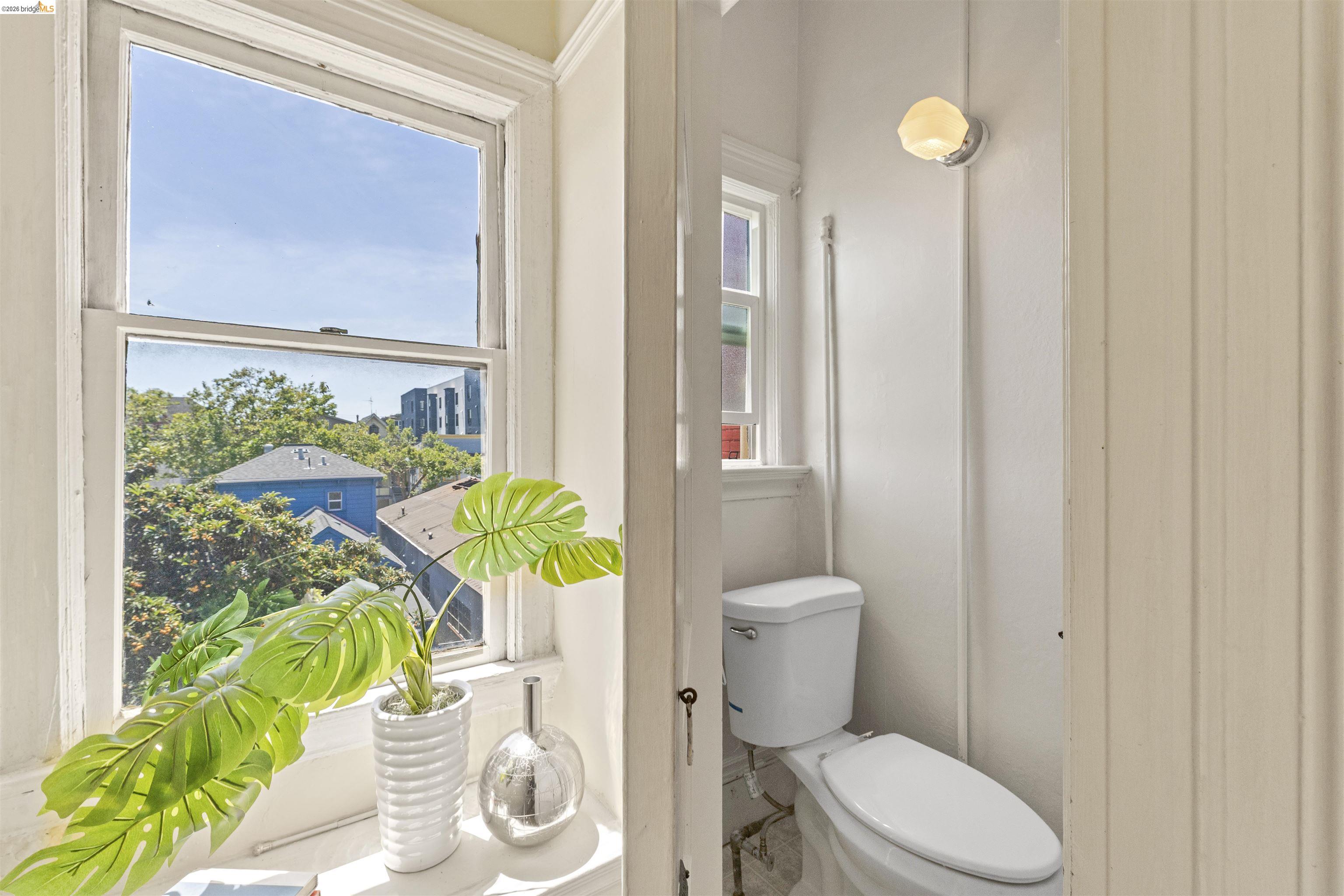 667 10th Street Oakland, CA 94607 - Photo 10 of 15 a white toilet sitting next to a bathroom sink