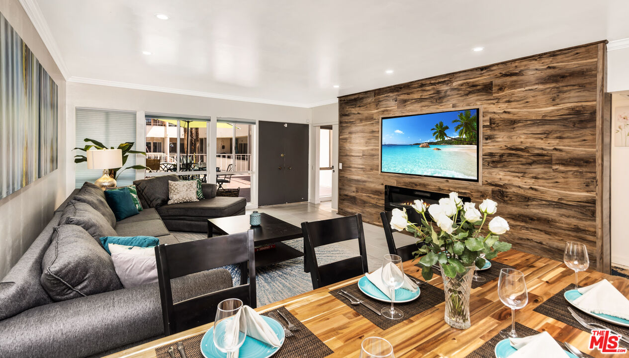 277 East Alejo Road, Unit 119 Palm Springs, CA 92262 - Photo 1 of 46 a living room with furniture and a flat screen tv