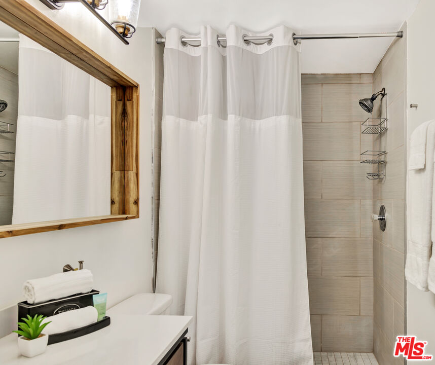 277 East Alejo Road, Unit 119 Palm Springs, CA 92262 - Photo 22 of 46 a bathroom with a sink mirror and shower