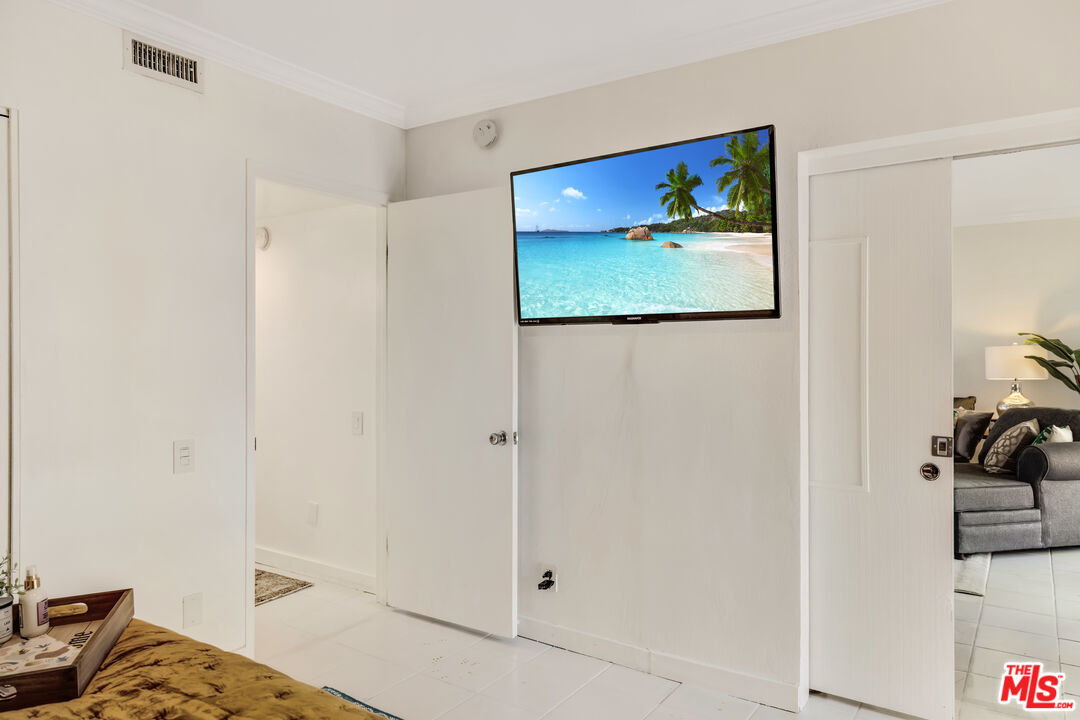 277 East Alejo Road, Unit 119 Palm Springs, CA 92262 - Photo 26 of 46 a view of a bedroom with bed and workspace