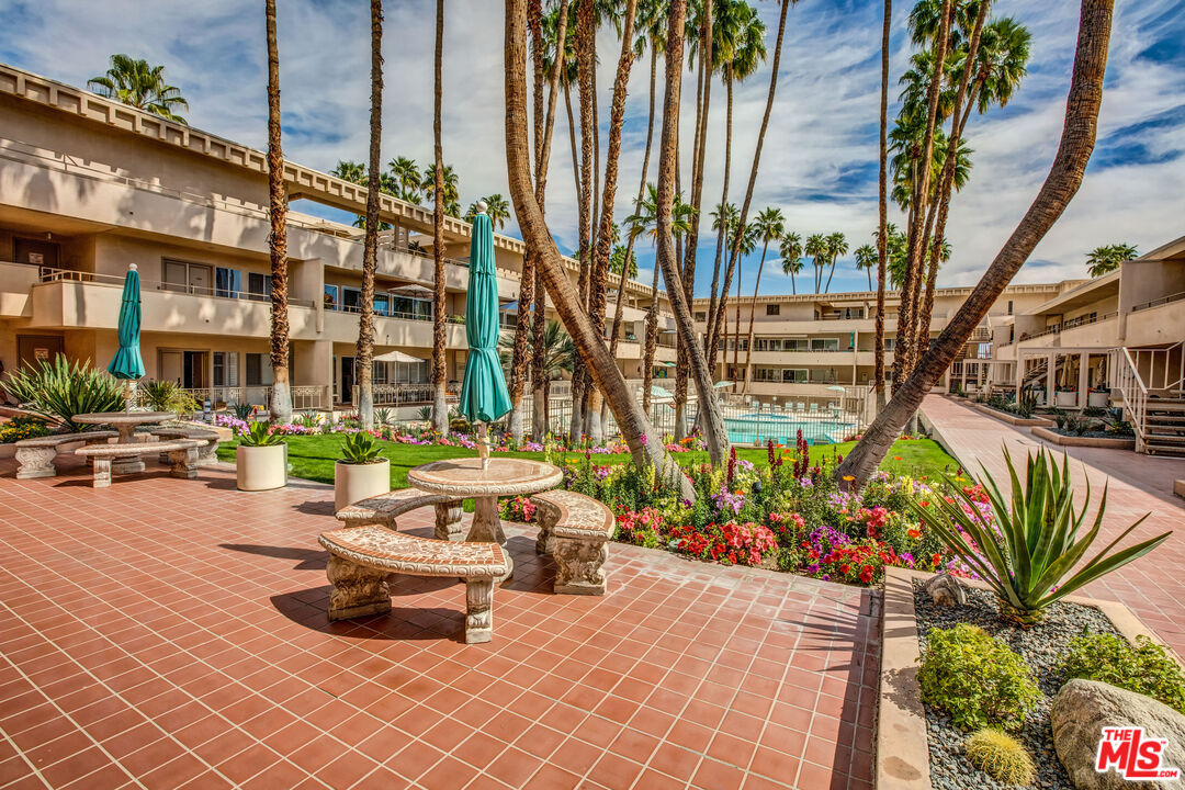 277 East Alejo Road, Unit 119 Palm Springs, CA 92262 - Photo 31 of 46 a swimming pool with outdoor seating and plants