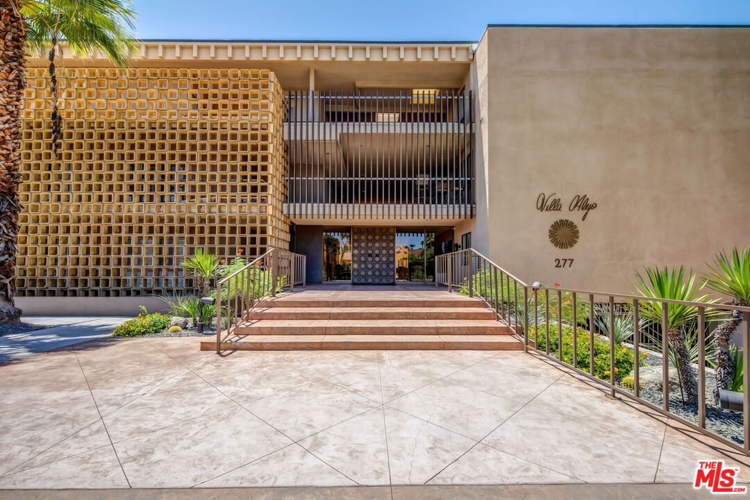 277 East Alejo Road, Unit 119 Palm Springs, CA 92262 - Photo 32 of 46 a view of entrance door of house and car parked