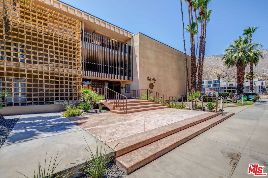 277 East Alejo Road, Unit 119 Palm Springs, CA 92262 - Photo 36 of 46 a house with palm tree in front of it