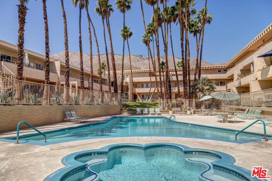 277 East Alejo Road, Unit 119 Palm Springs, CA 92262 - Photo 37 of 46 a swimming pool with outdoor seating and yard