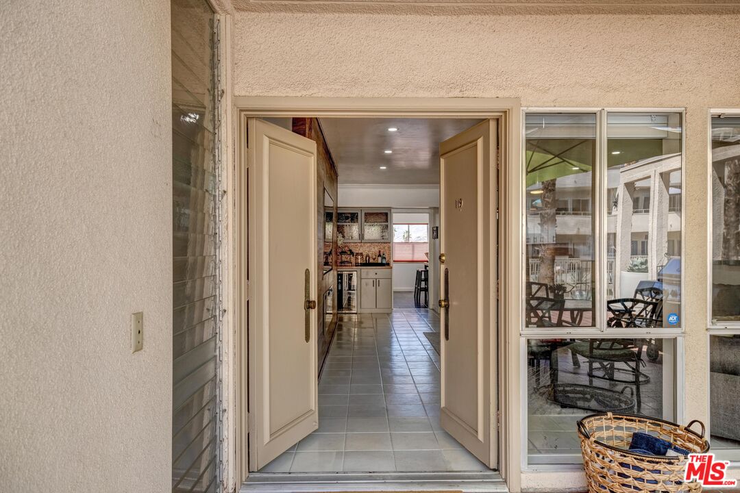 277 East Alejo Road, Unit 119 Palm Springs, CA 92262 - Photo 6 of 46 a view of a hallway with wooden floor and a living room