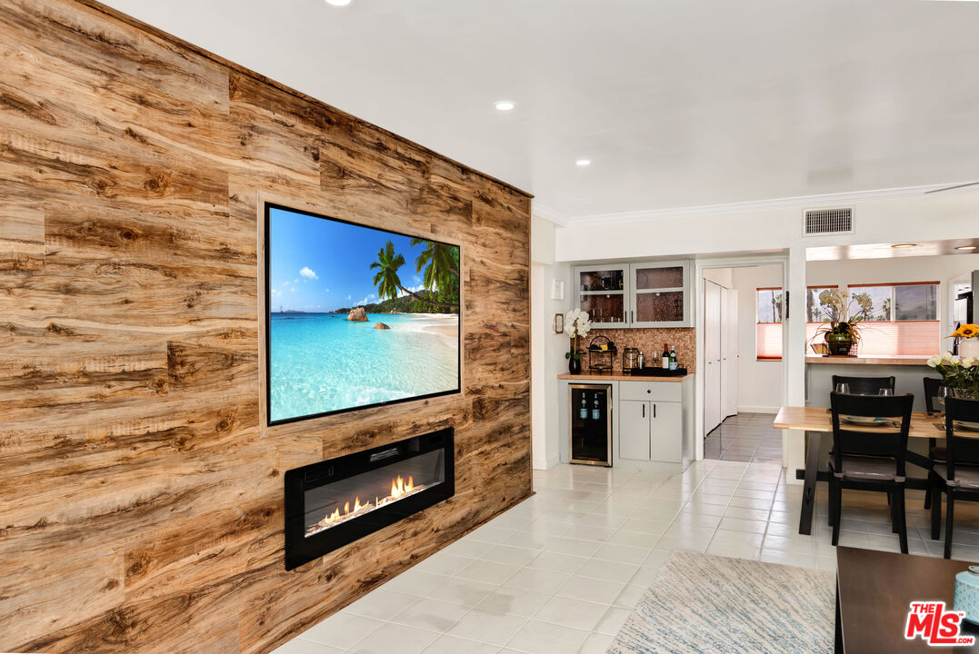 277 East Alejo Road, Unit 119 Palm Springs, CA 92262 - Photo 8 of 46 a living room with furniture a flat screen tv and a fireplace