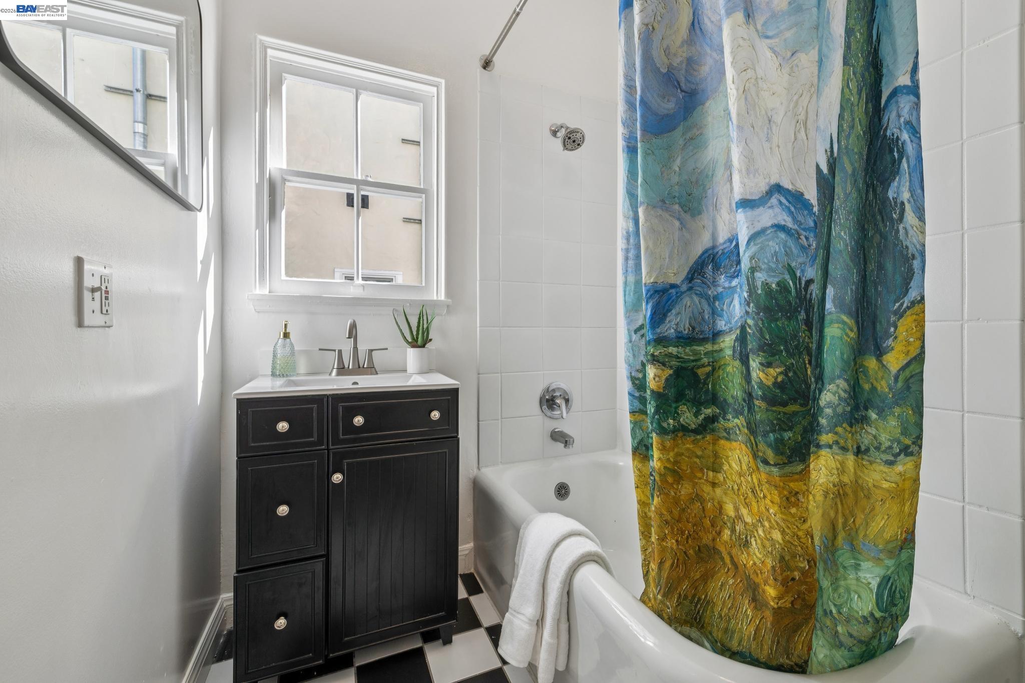 2365 Virginia Street, Unit 2 Berkeley, CA 94709 - Photo 16 of 19 a bathroom with a granite countertop sink a mirror and bathtub
