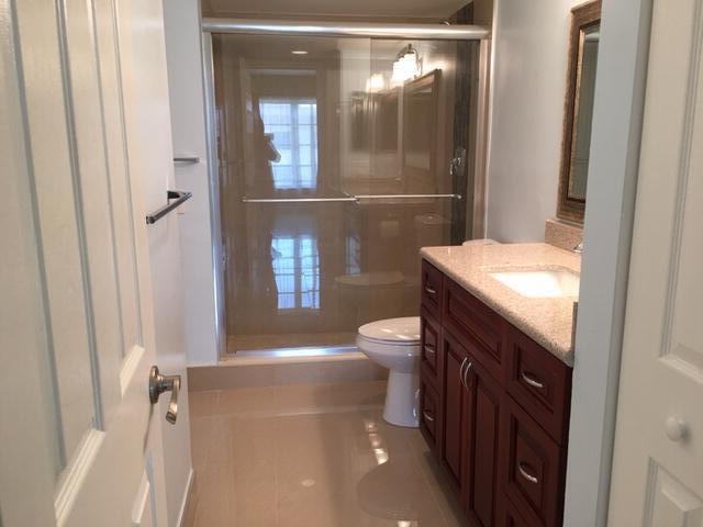 4154 Inverrary Drive, Unit 407 Lauderhill, FL 33319 - Photo 12 of 39 a bathroom with a granite countertop sink a toilet a mirror and shower