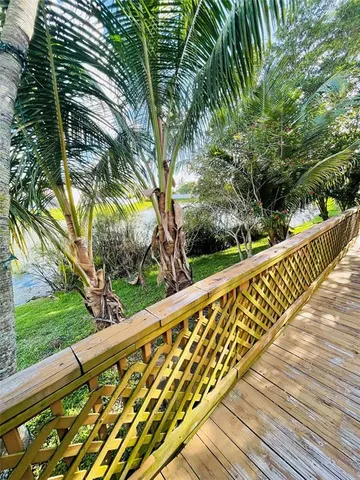 a view of balcony with wooden floor and fence