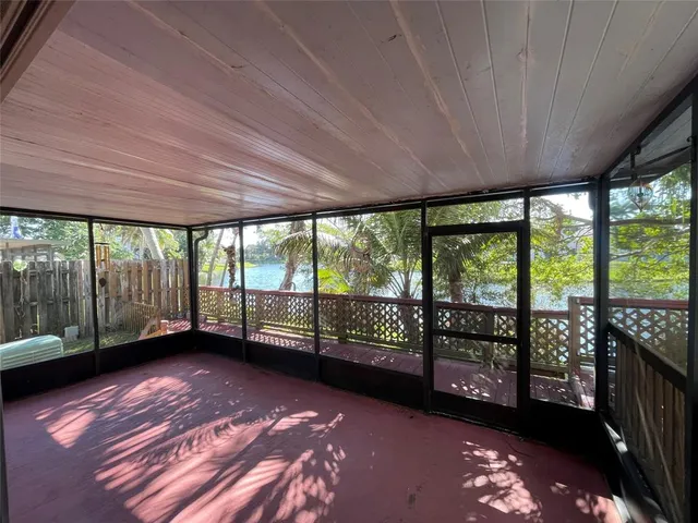 a view of empty room with floor to ceiling window