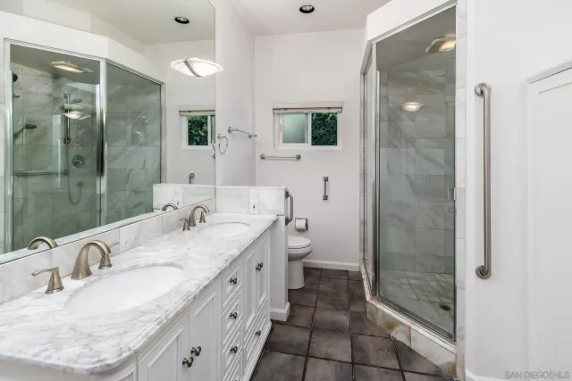 a spacious bathroom with a granite countertop tub sink and mirror