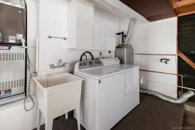 a view of backyard with potted plants and a bench