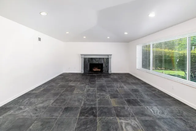 a view of an empty room with a fireplace