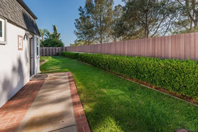 a house with green field in front of it