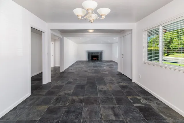 a large kitchen with stainless steel appliances a large counter top a stove a chimney a sink and cabinets