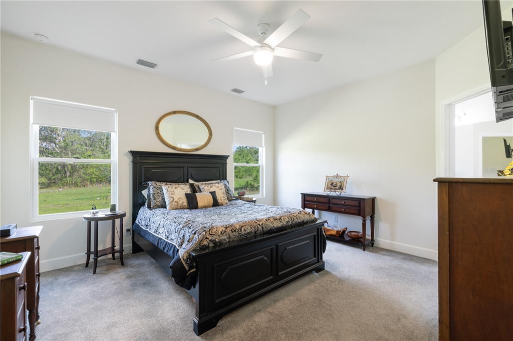 5149 Southwest 119th Road Lake Butler, FL 32054 - Photo 21 of 40 a bedroom with a bed table chair and a window