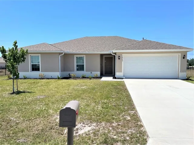 a front view of house with yard and trees
