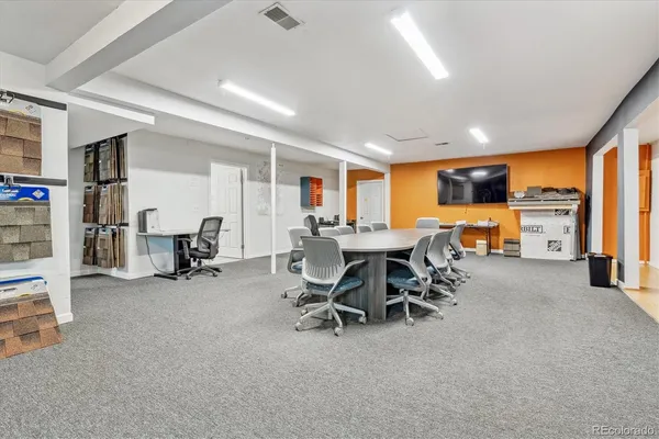 a view of a livingroom with furniture and a work space