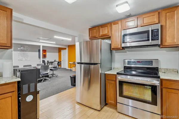 a kitchen with stainless steel appliances granite countertop a refrigerator stove top oven a sink and dishwasher