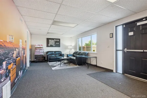 a view of a livingroom with furniture and a window