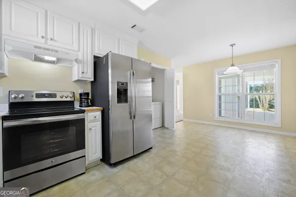 a kitchen with stainless steel appliances a stove a refrigerator and a sink