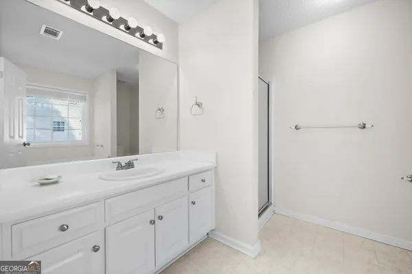 a spacious bathroom with a double vanity sink mirror and