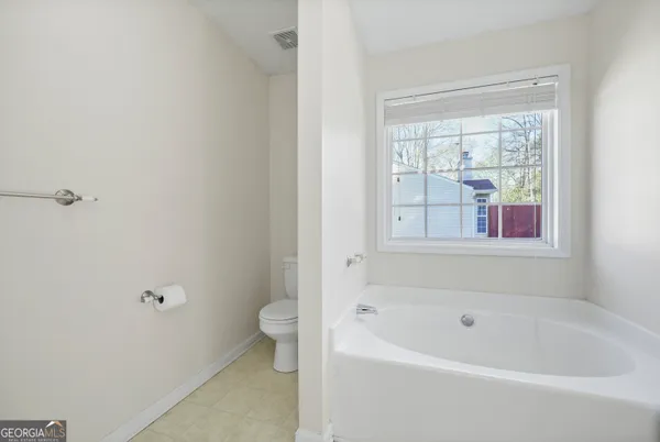 a bathroom with a bathtub and window
