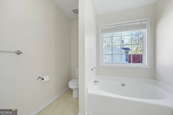 a bathroom with a bathtub and window