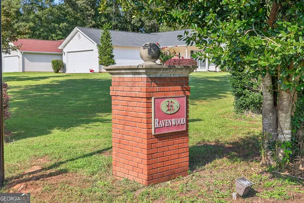 a sign board with a yard