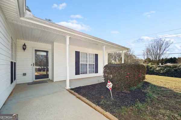 a front view of a house with garden