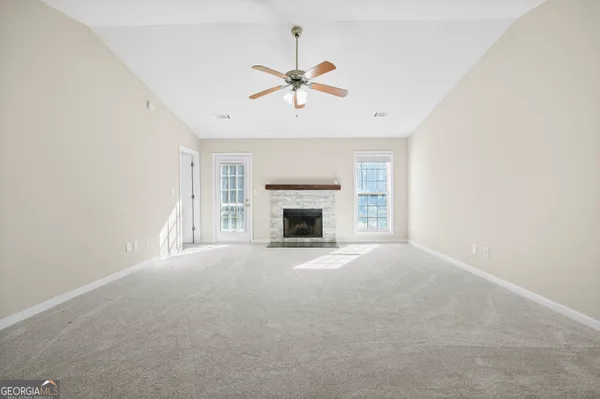 a view of an empty room with a fireplace