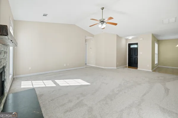 a view of an empty room with a fireplace