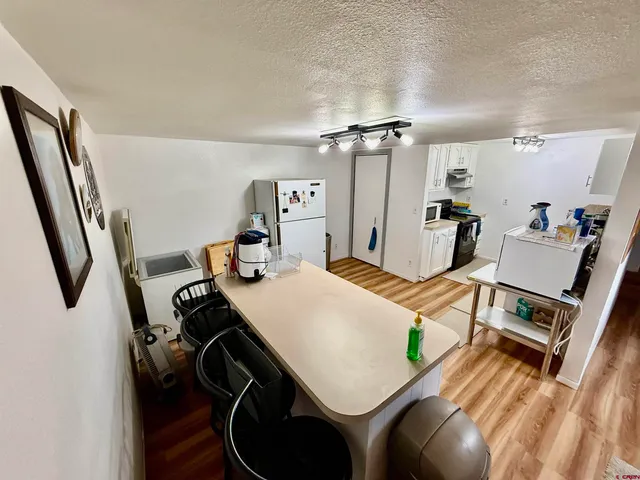 a kitchen with white cabinets and white appliances