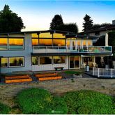a front view of a house with swimming pool having outdoor seating