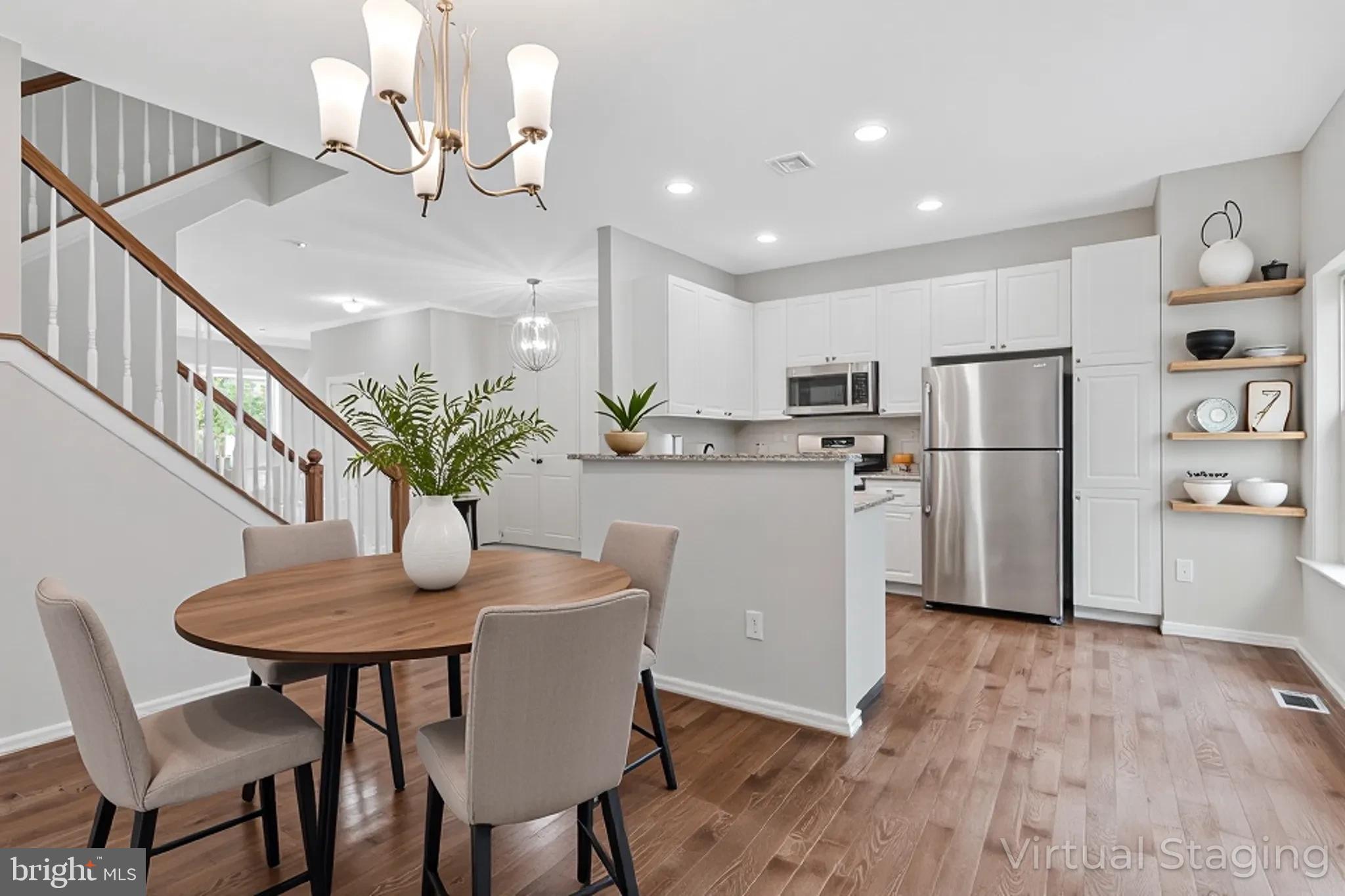 12033 Edgemere Circle Reston, VA 20190 - Photo 11 of 53 a dining room with furniture a chandelier and wooden floor