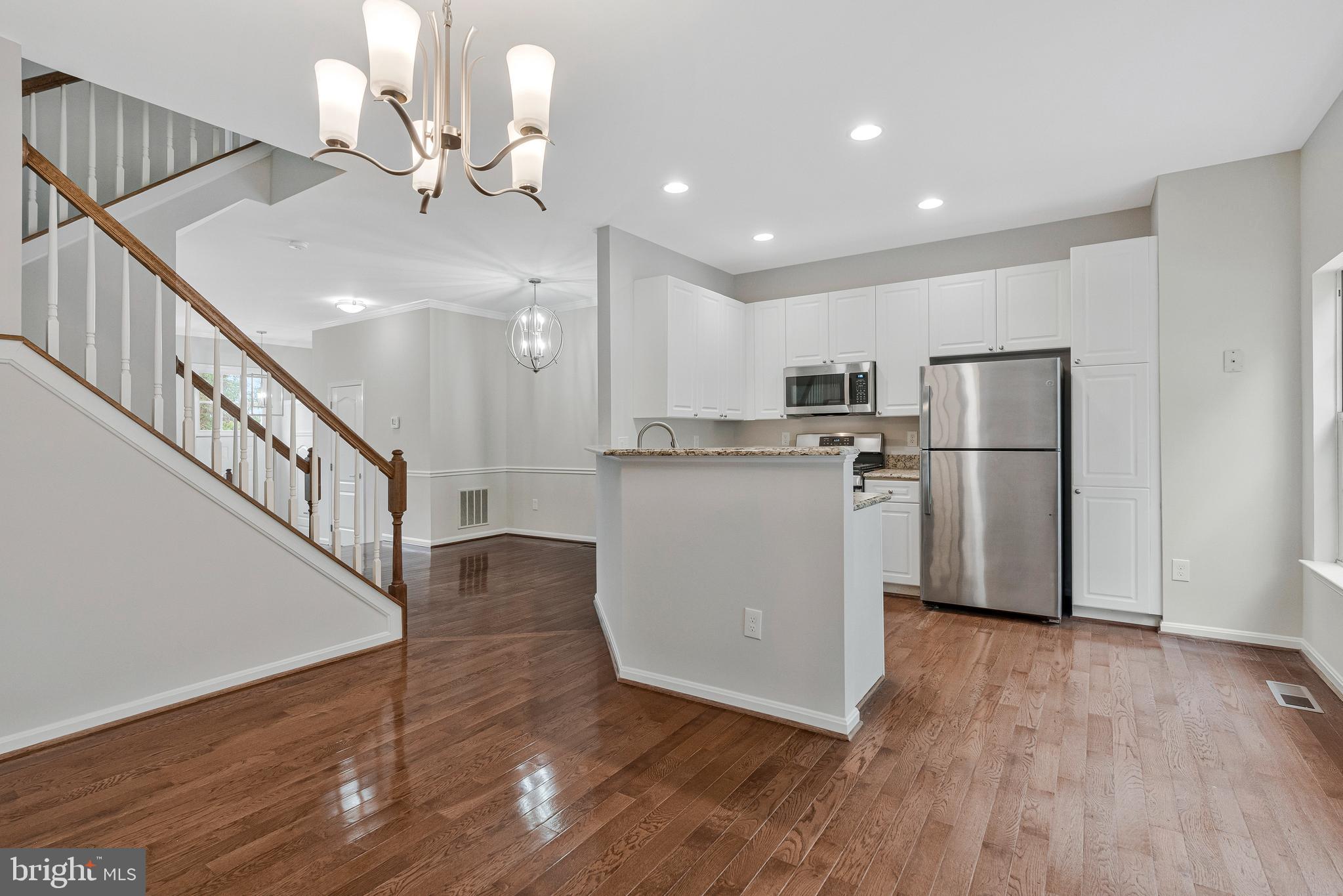 12033 Edgemere Circle Reston, VA 20190 - Photo 12 of 53 a view of a kitchen with wooden floor and electronic appliances